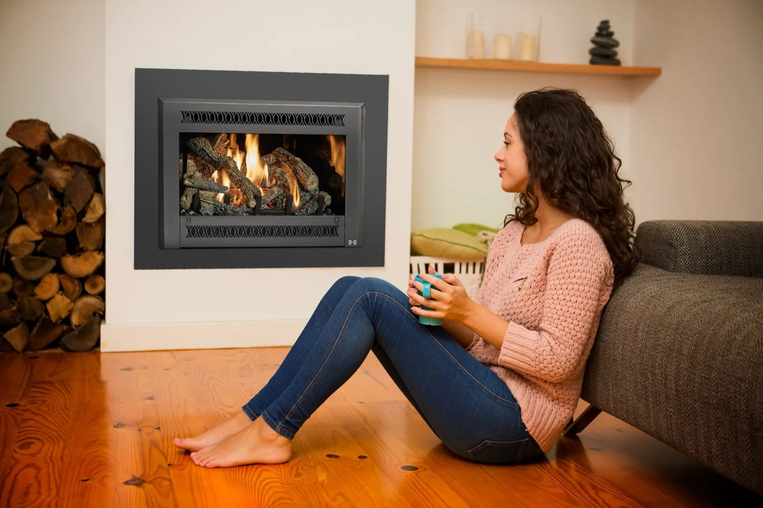 Woman enjoying coffee beside a gas fireplace insert on a quiet Montana morning
