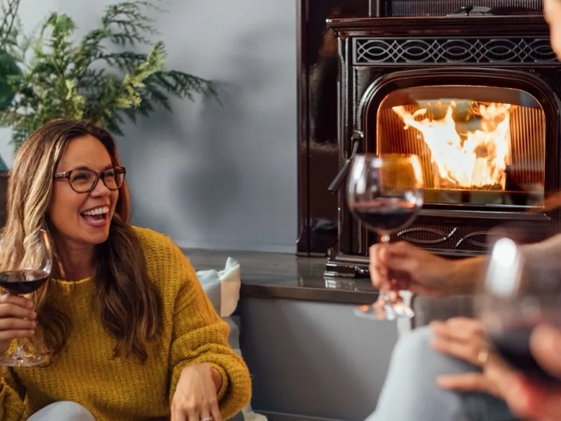 Woman enjoying a quiet evening by a Harman fireplace insert in Southwest Montana