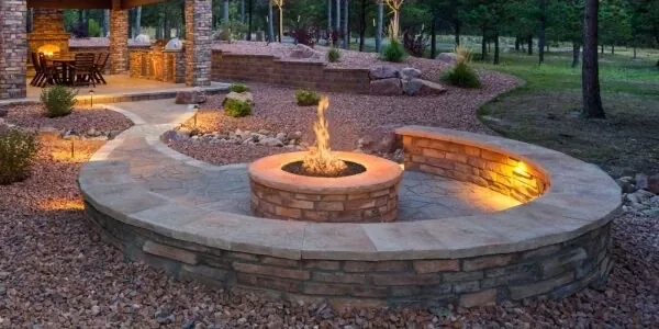 Outdoor fire pit glowing on a Montana patio at dusk